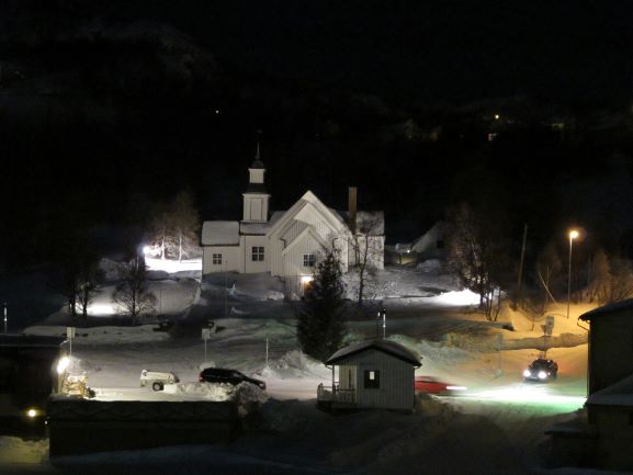 Blick nachts auf eine angestrahlte weisse Kirche